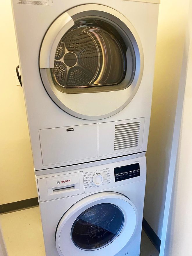A clean stacked washer and dryer