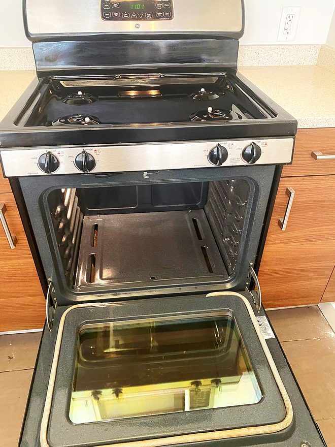 A finished range with clean cooktop, front panel and open oven